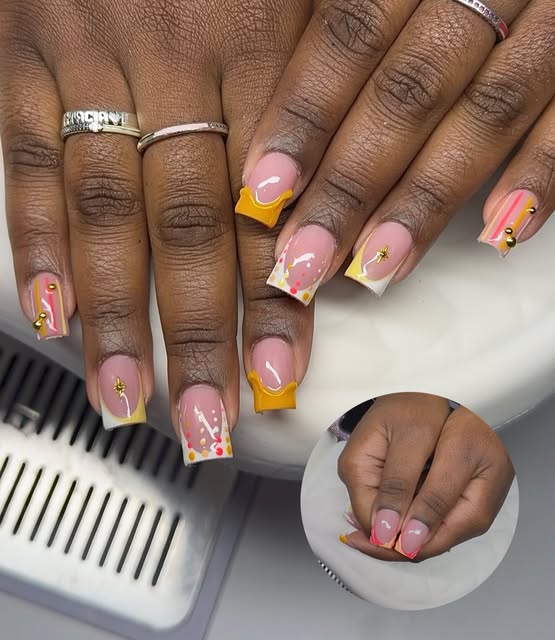 Square French-tip nail set in pink and yellow with abstract floral accents