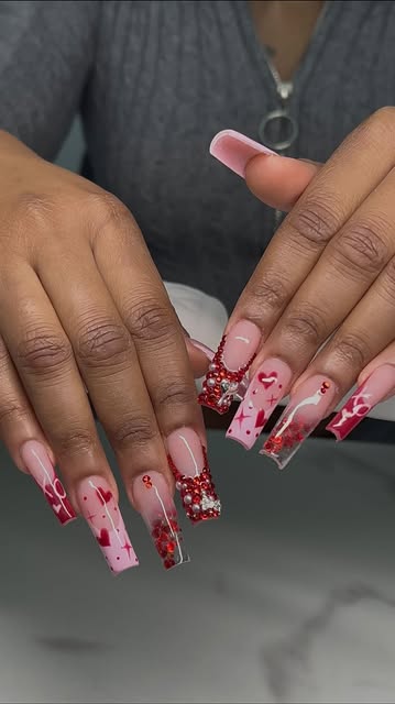 Long pink Valentine nail set with red crystals, hearts, and French-tip art