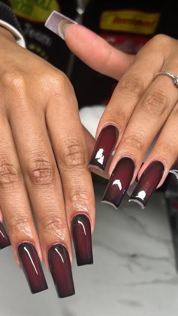 Long square burgundy ombre nail set with a glossy finish